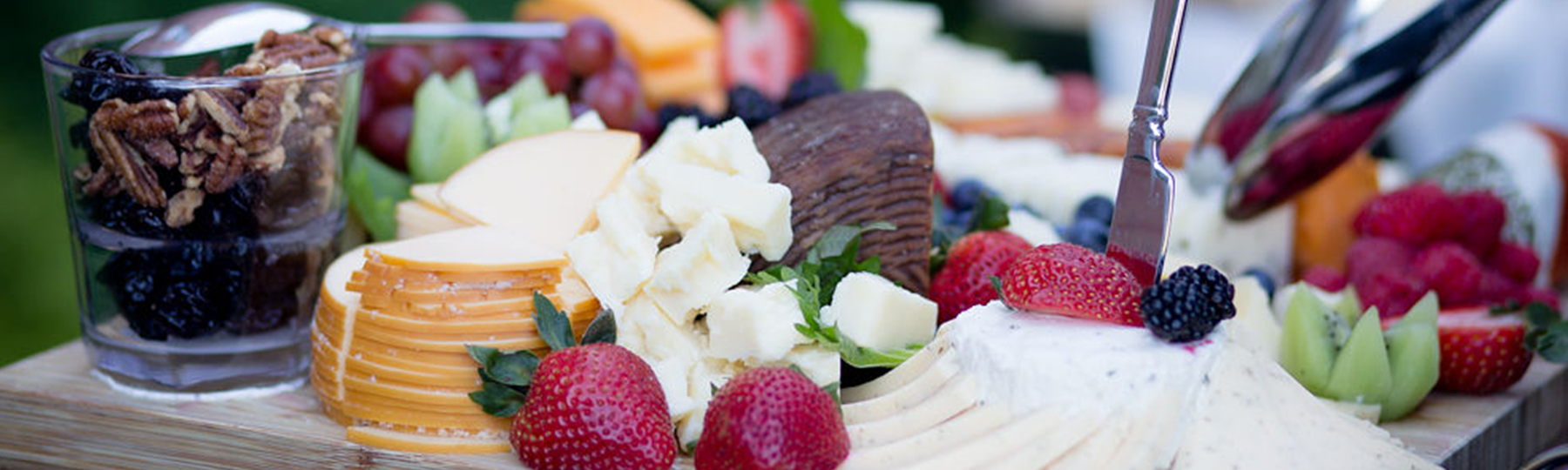 Cheese assortment on wooden serving tray